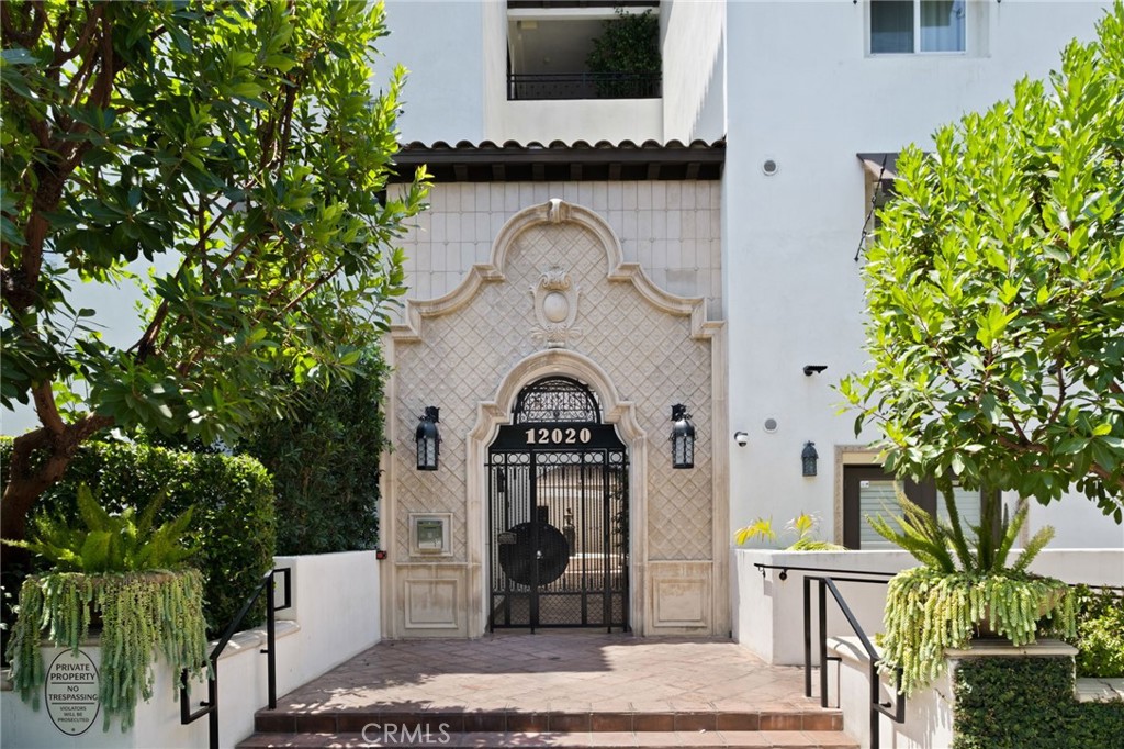 a view of front door of house and yard with seating area