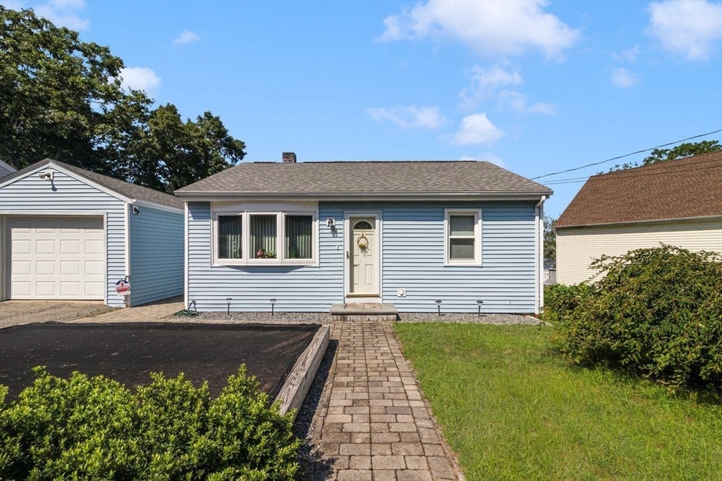 a front view of a house with a garden