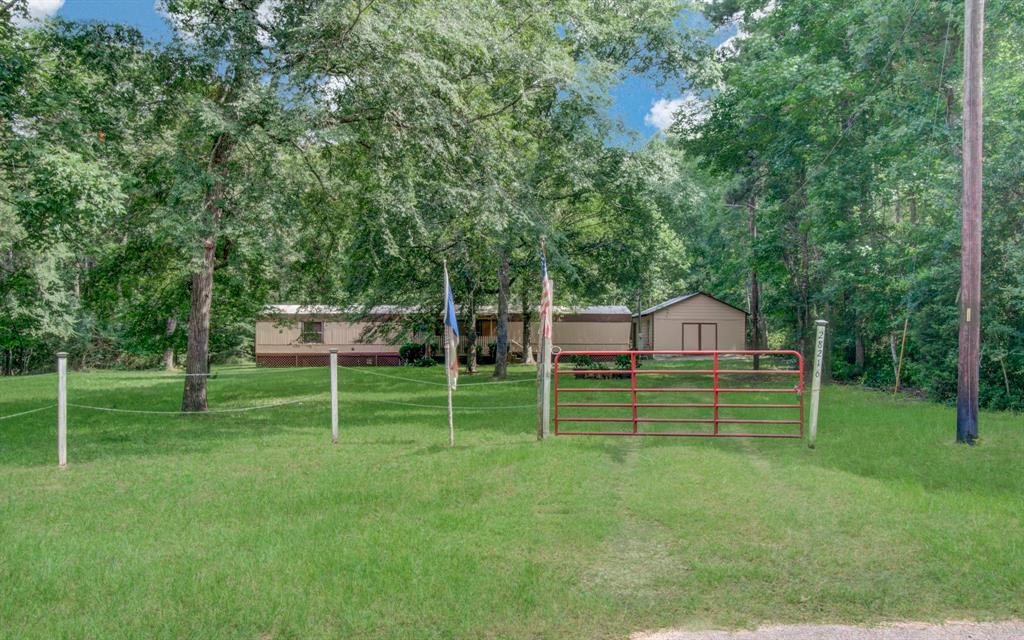 a view of a wooden deck and a big yard