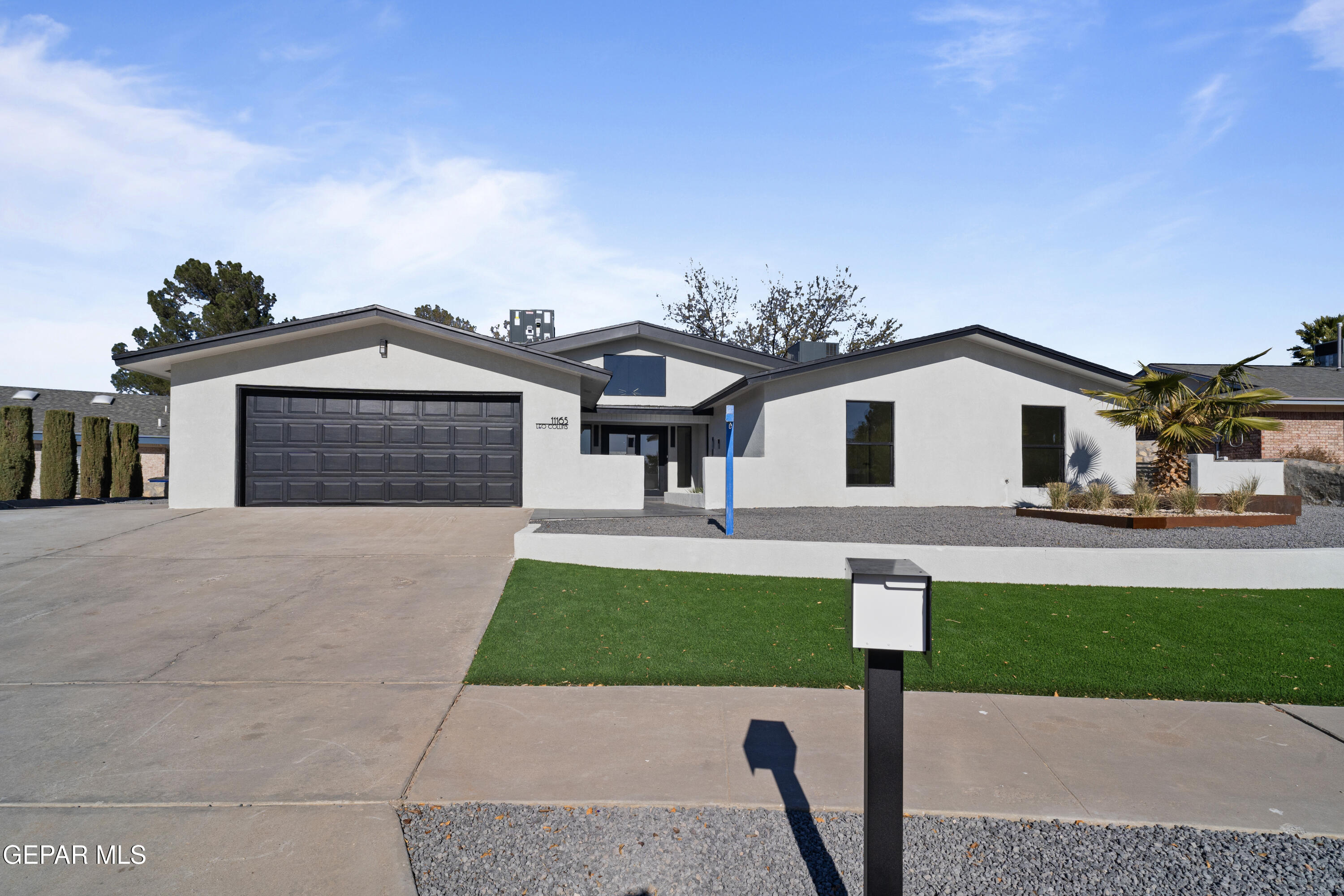 a front view of a house with a garden and yard