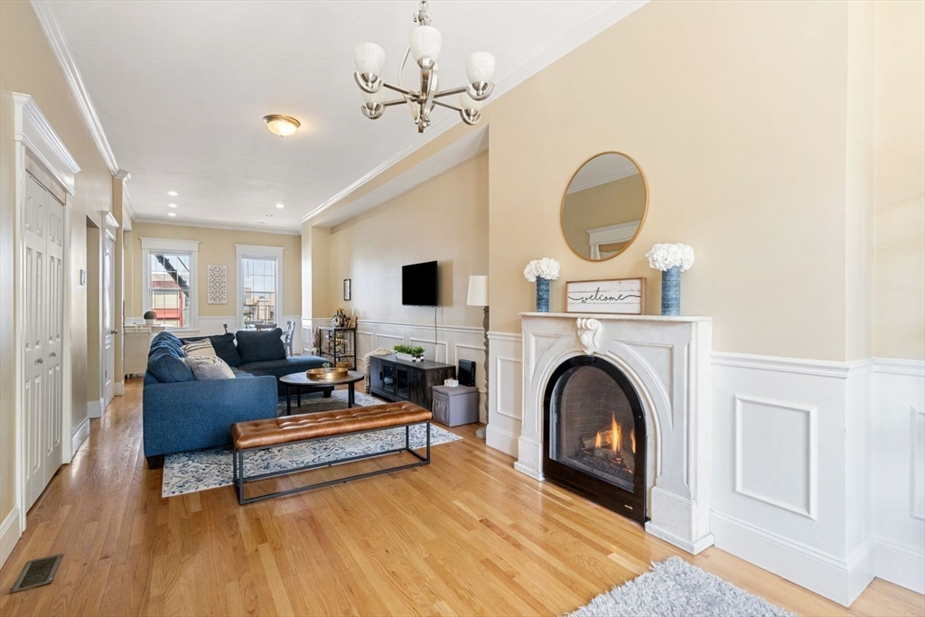 a living room with furniture a fireplace and a rug