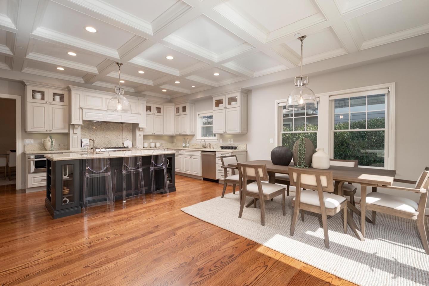 a living room with stainless steel appliances kitchen island granite countertop a dining table chairs and view of living room