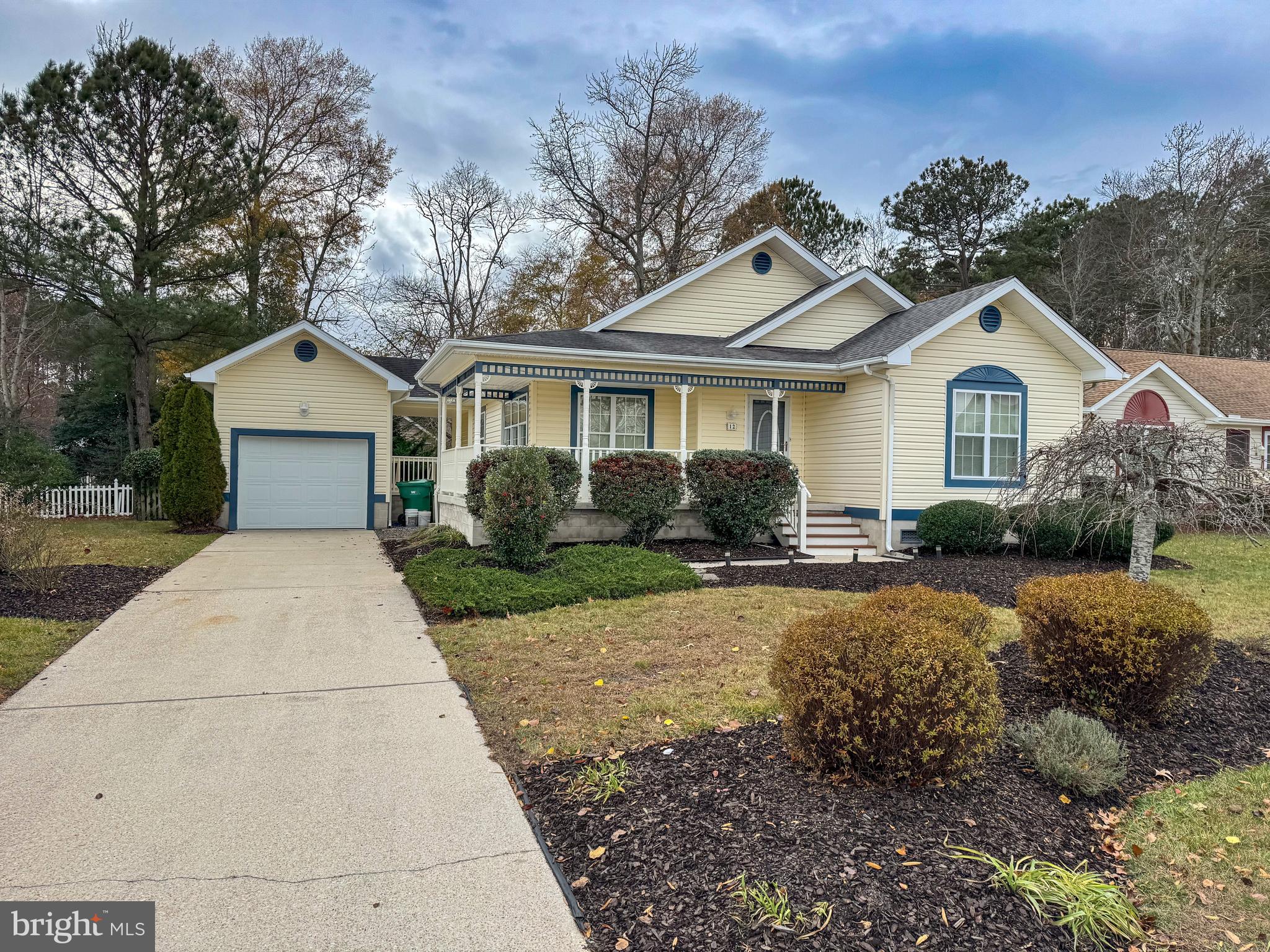 a front view of a house with a garden and yard