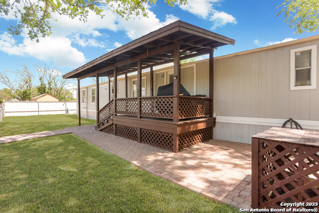 a view of backyard with deck and garden