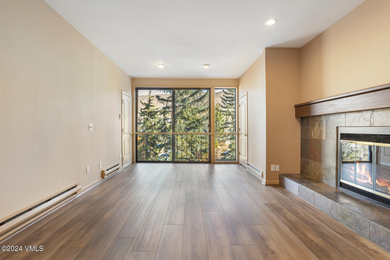 wooden floor in an empty room with a window