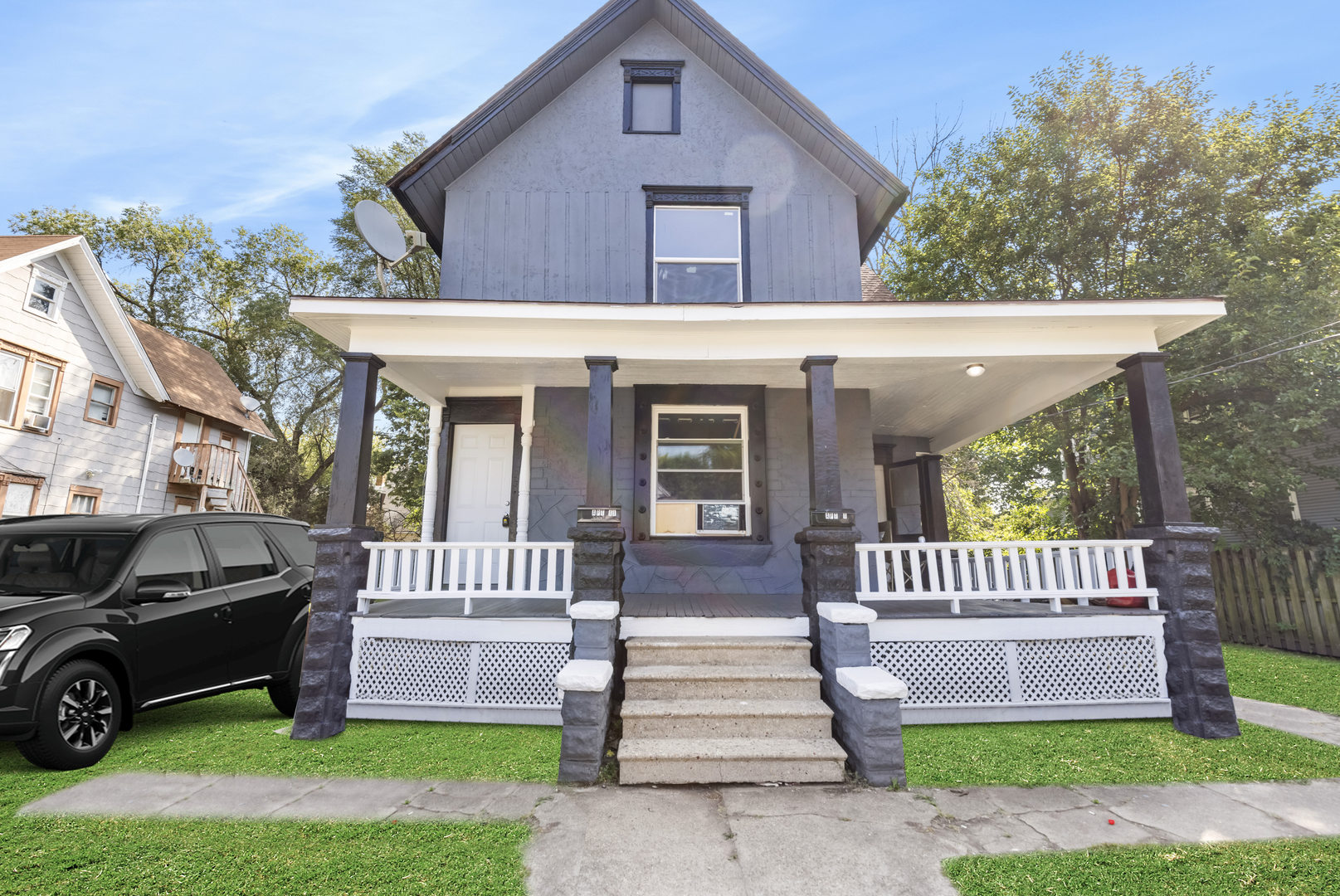 a view of a house with a patio and a garden