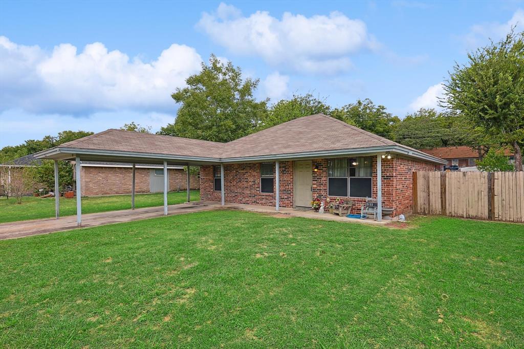 a view of a house with a yard and sitting area