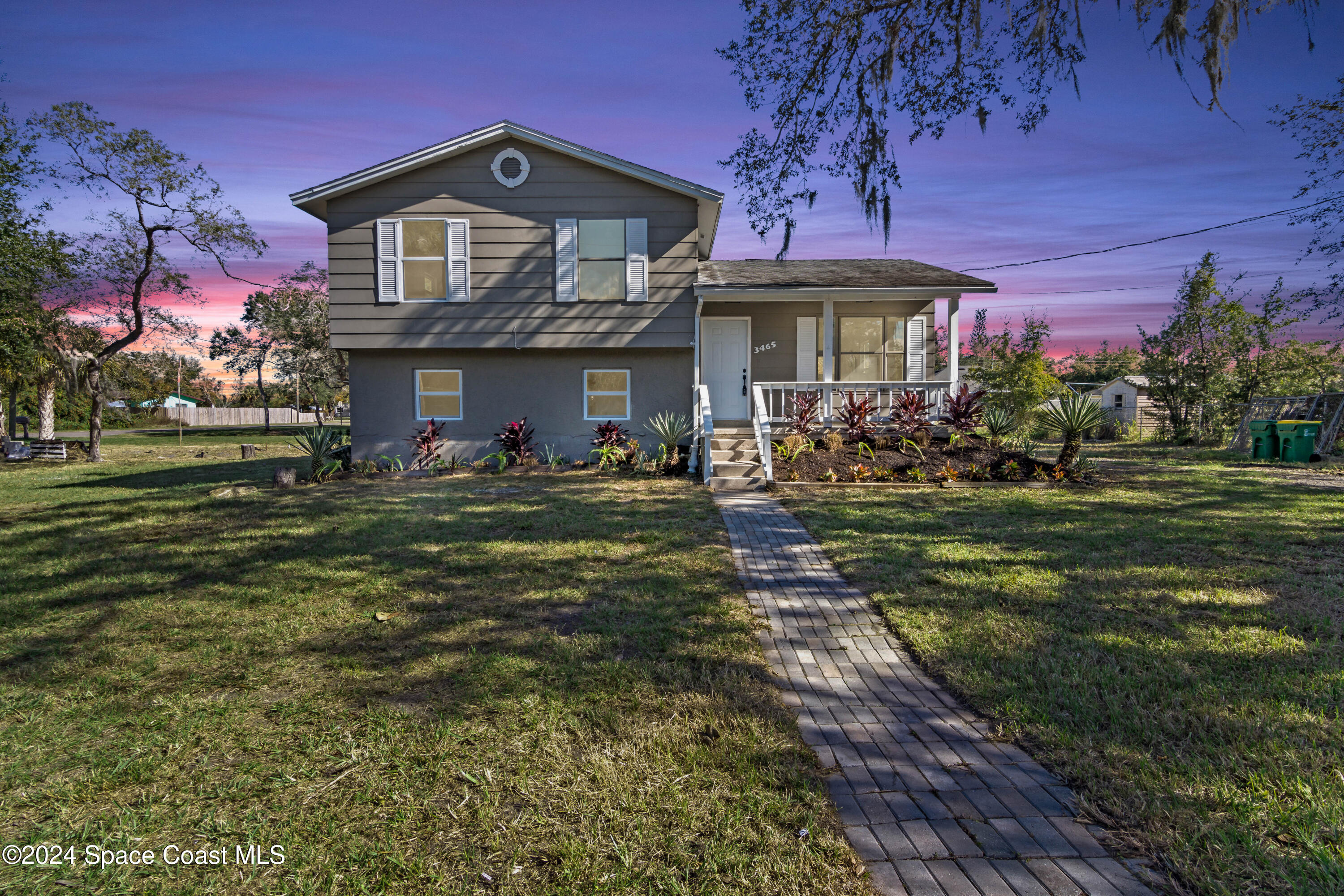 a front view of a house with a garden