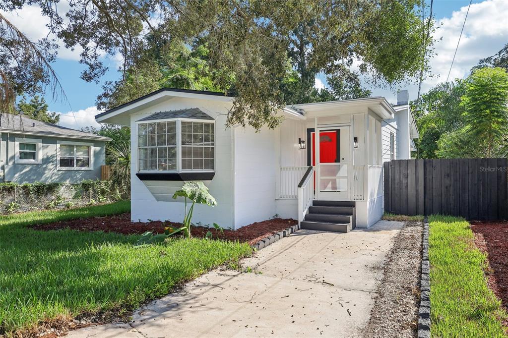 a front view of a house with a yard and fence