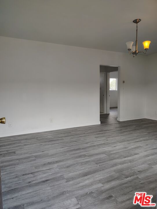 a view of an empty room and wooden floor