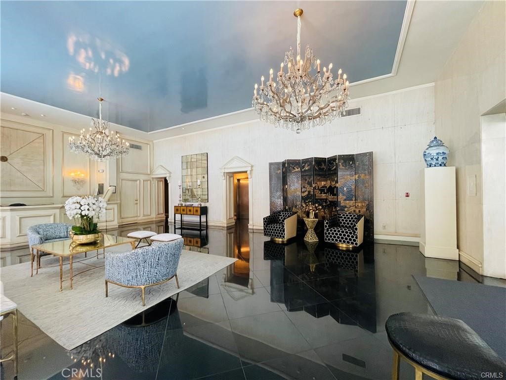 a living room with fireplace furniture and a chandelier