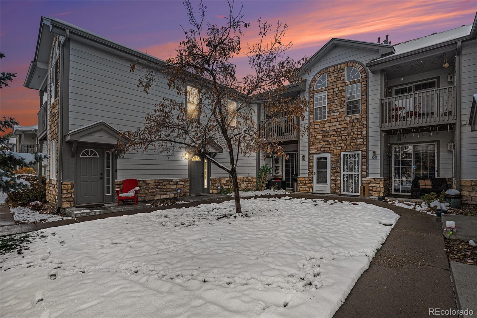 a view of a house with snow on the side of the road