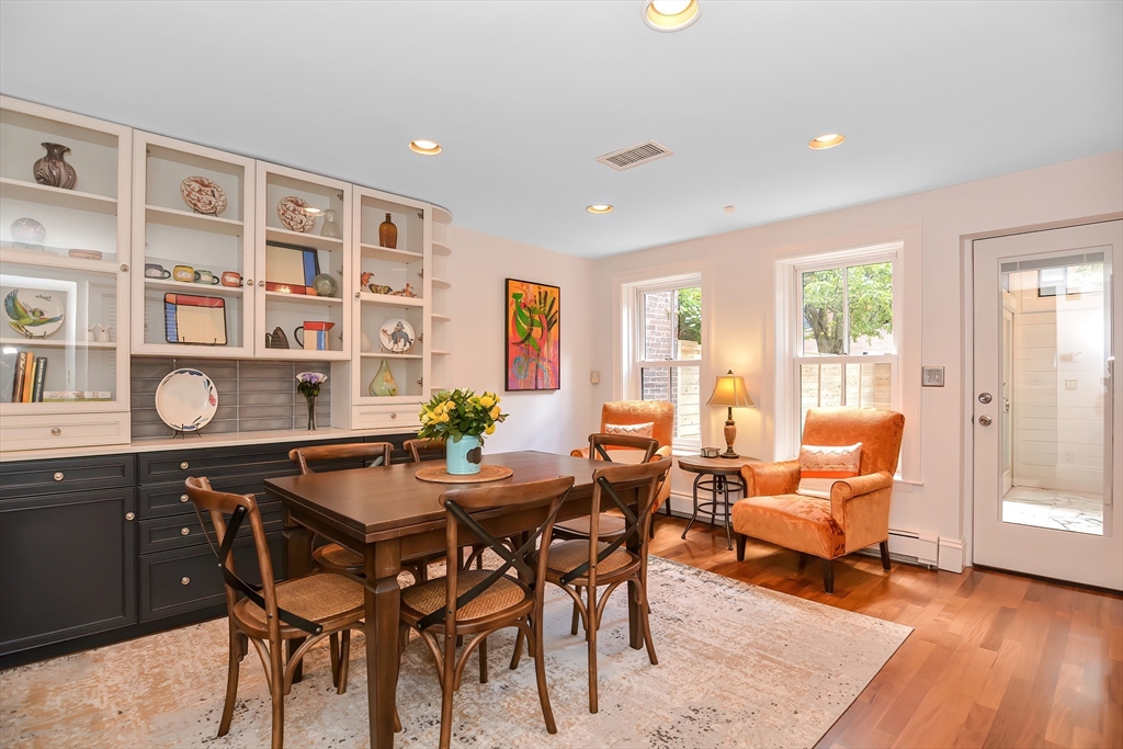 a dining room with a wooden table and chairs