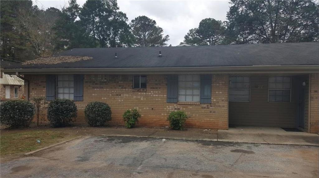 a front view of a house with parking space