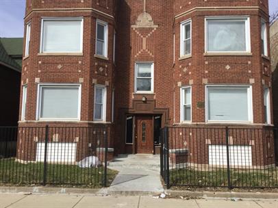 front view of a brick house with a large windows