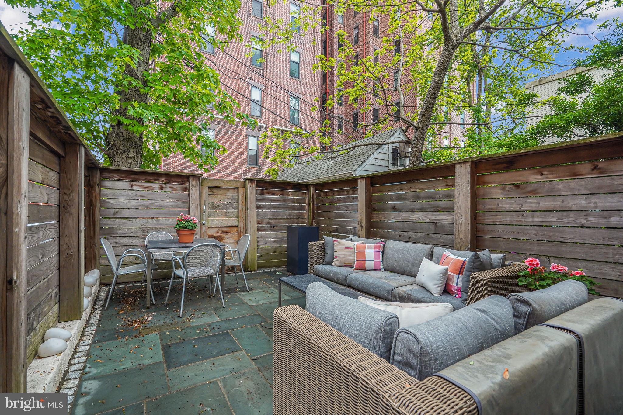 a outdoor living space with patio furniture and potted plants