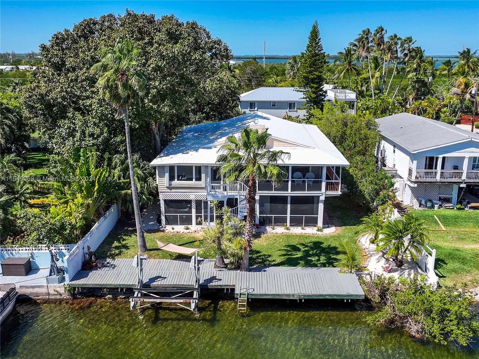 a aerial view of a house with swimming pool and garden