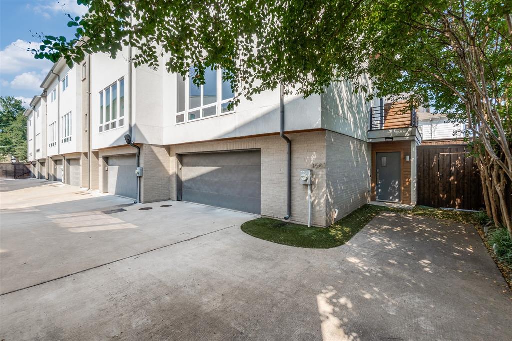 a front view of a house with a yard and tree s