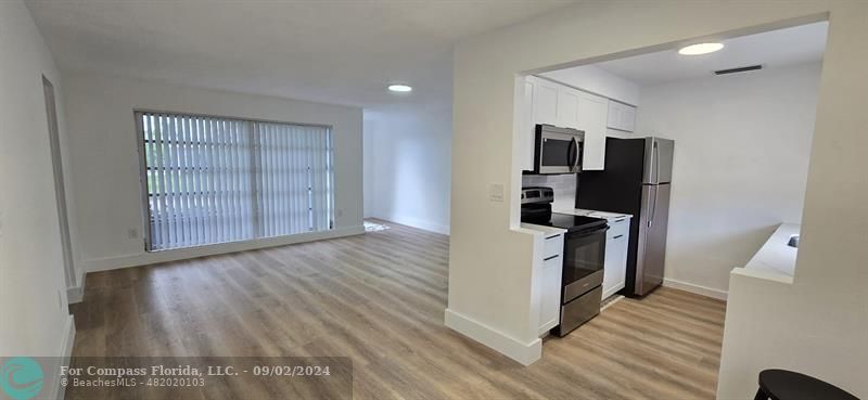 a view of kitchen and wooden floor