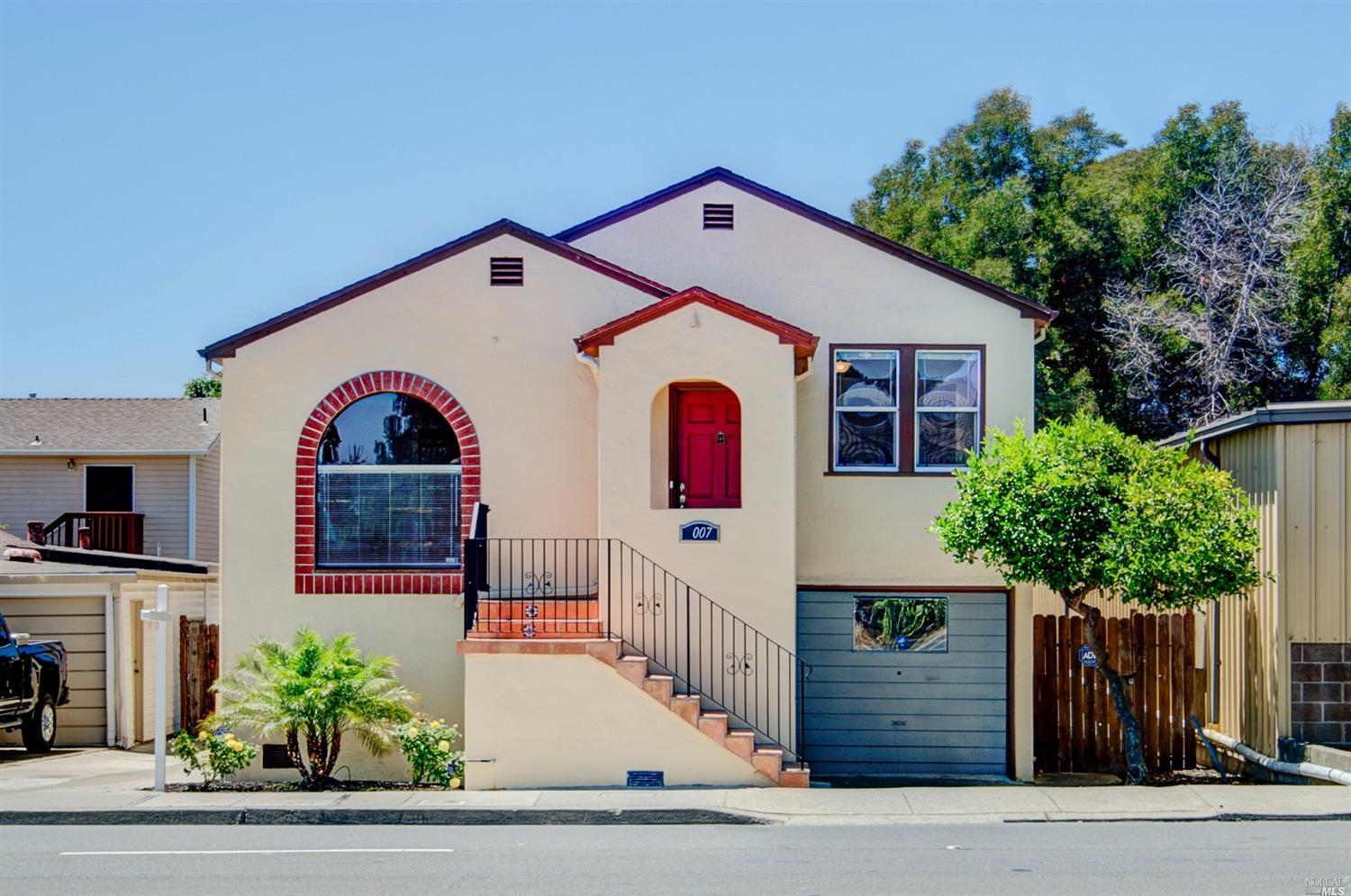 a front view of a house with plants