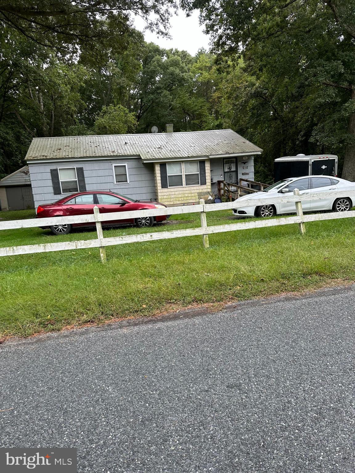 a front view of house with yard seating and green space