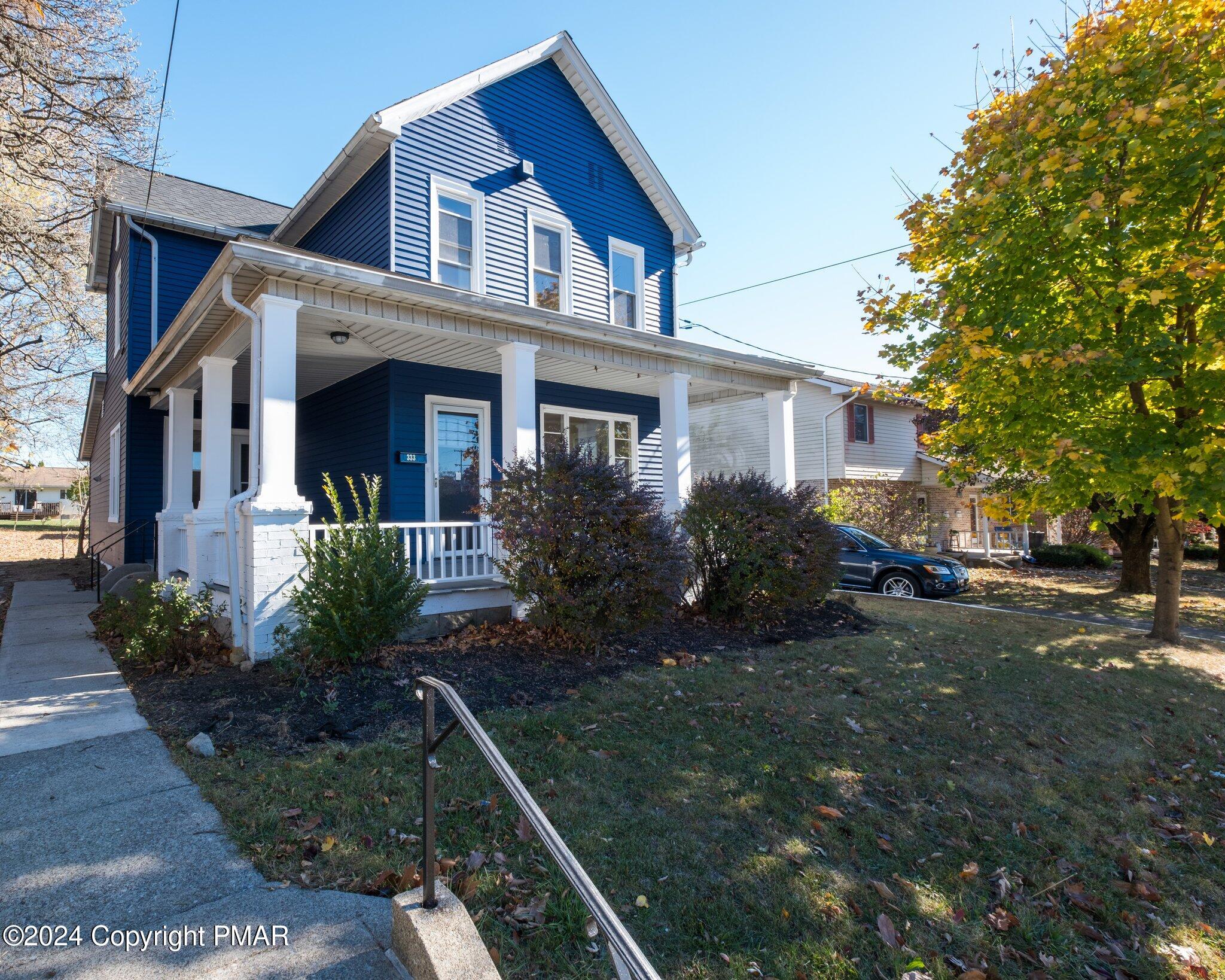 a front view of house with yard and green space