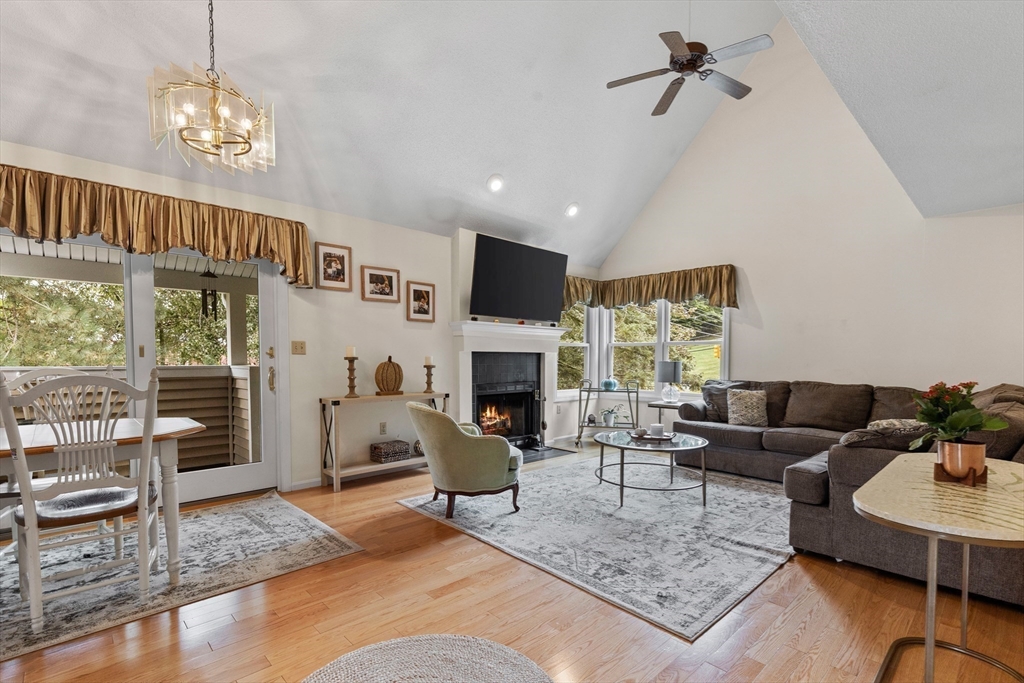 a living room with furniture a fireplace and a chandelier