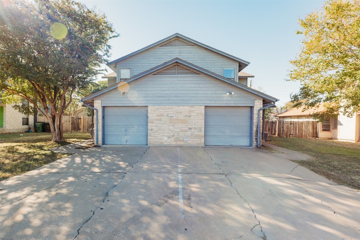 a view of a house with a yard and garage