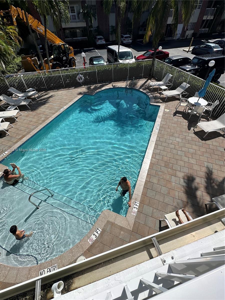 a view of a swimming pool with a yard