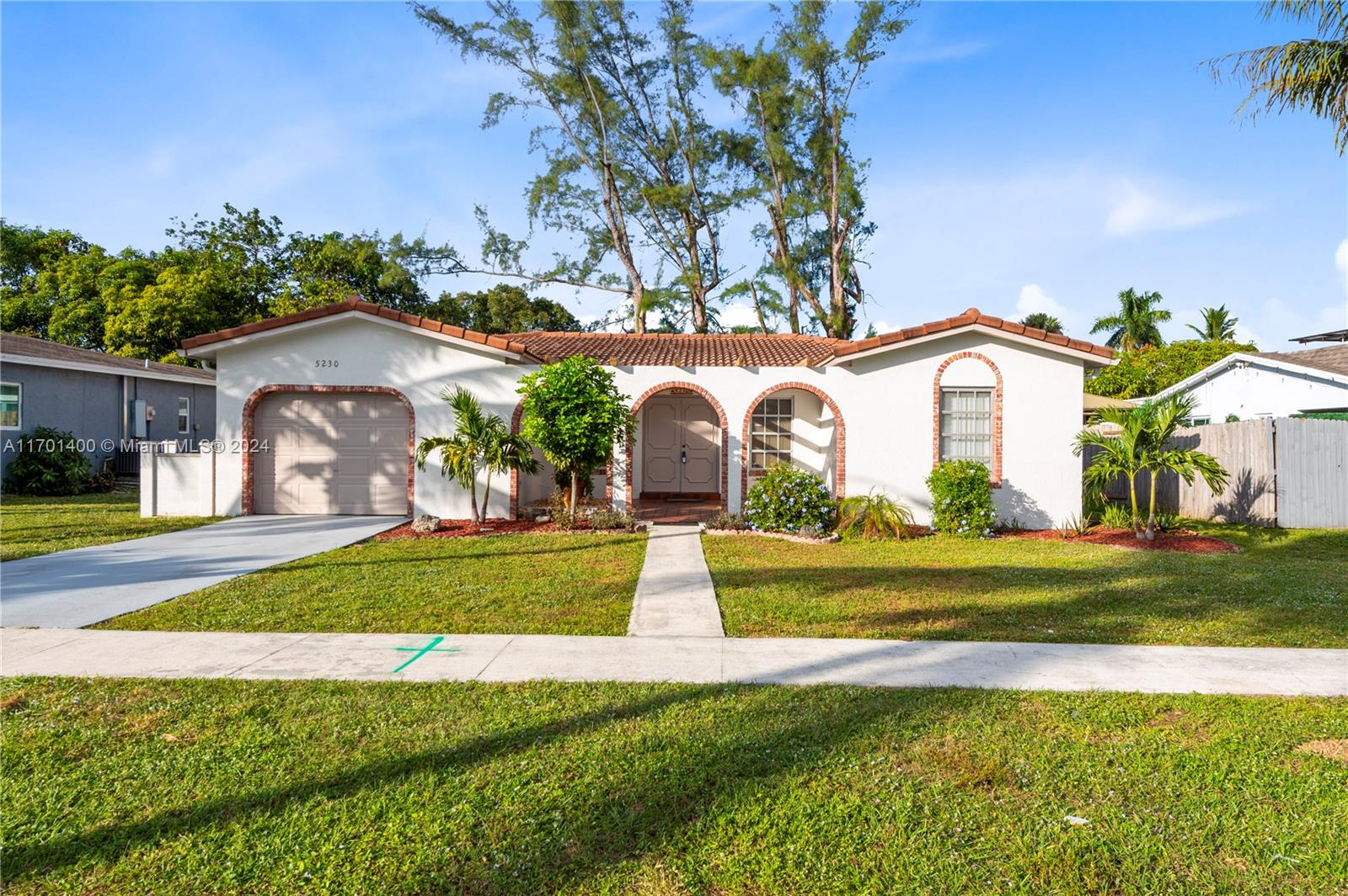 a front view of house with yard and green space