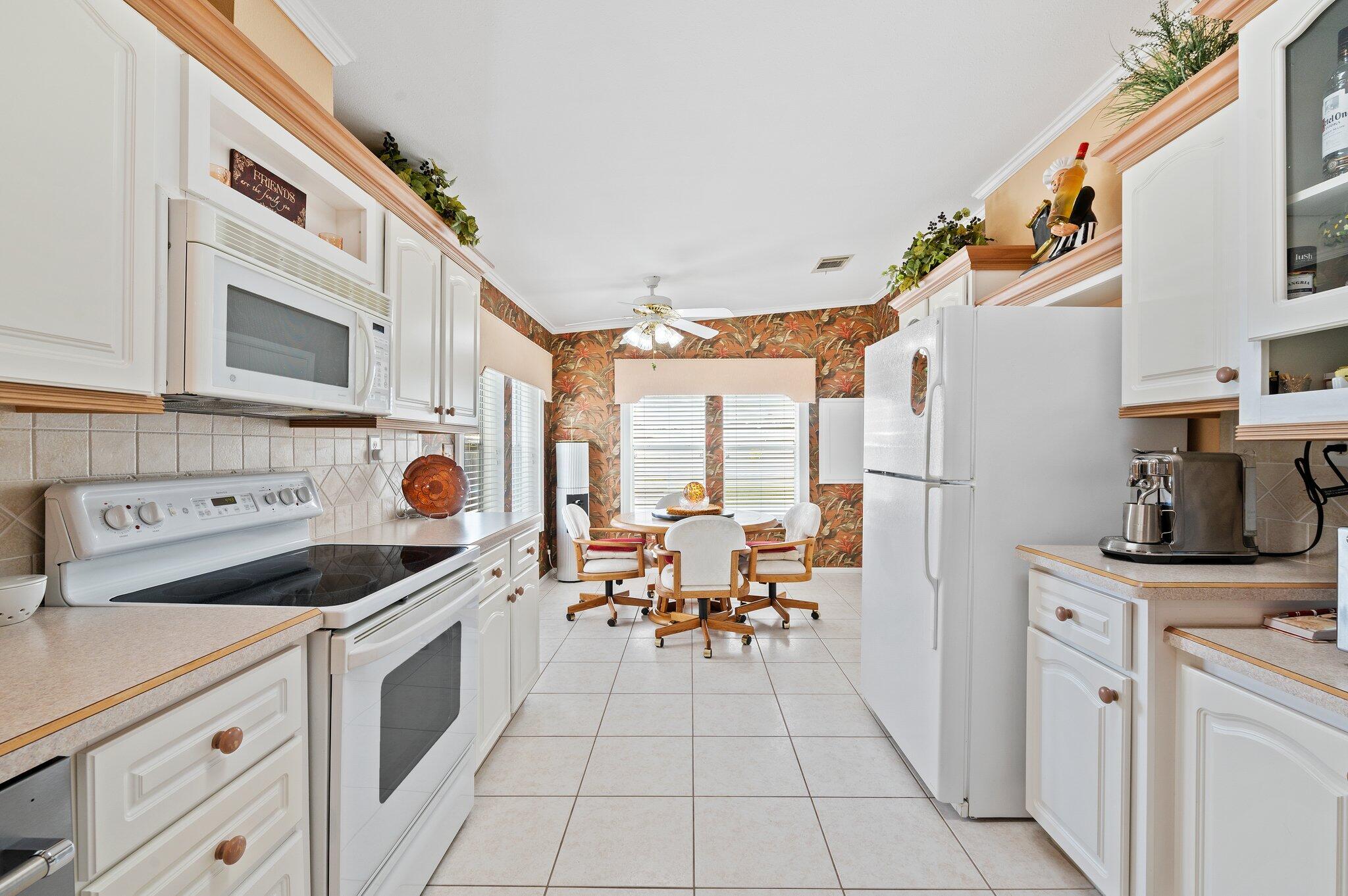 a kitchen with a sink a stove and cabinets