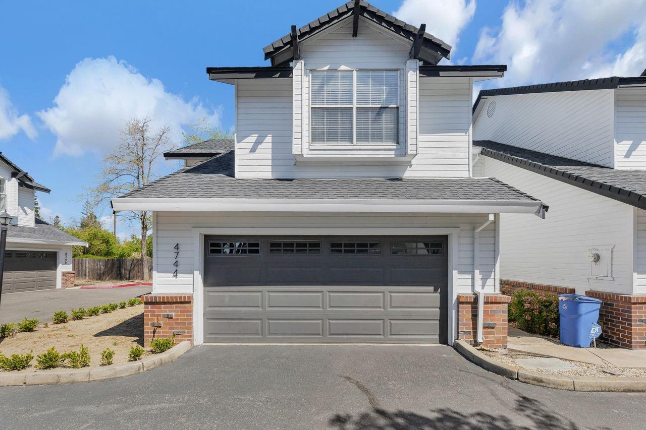 a front view of a house with garage