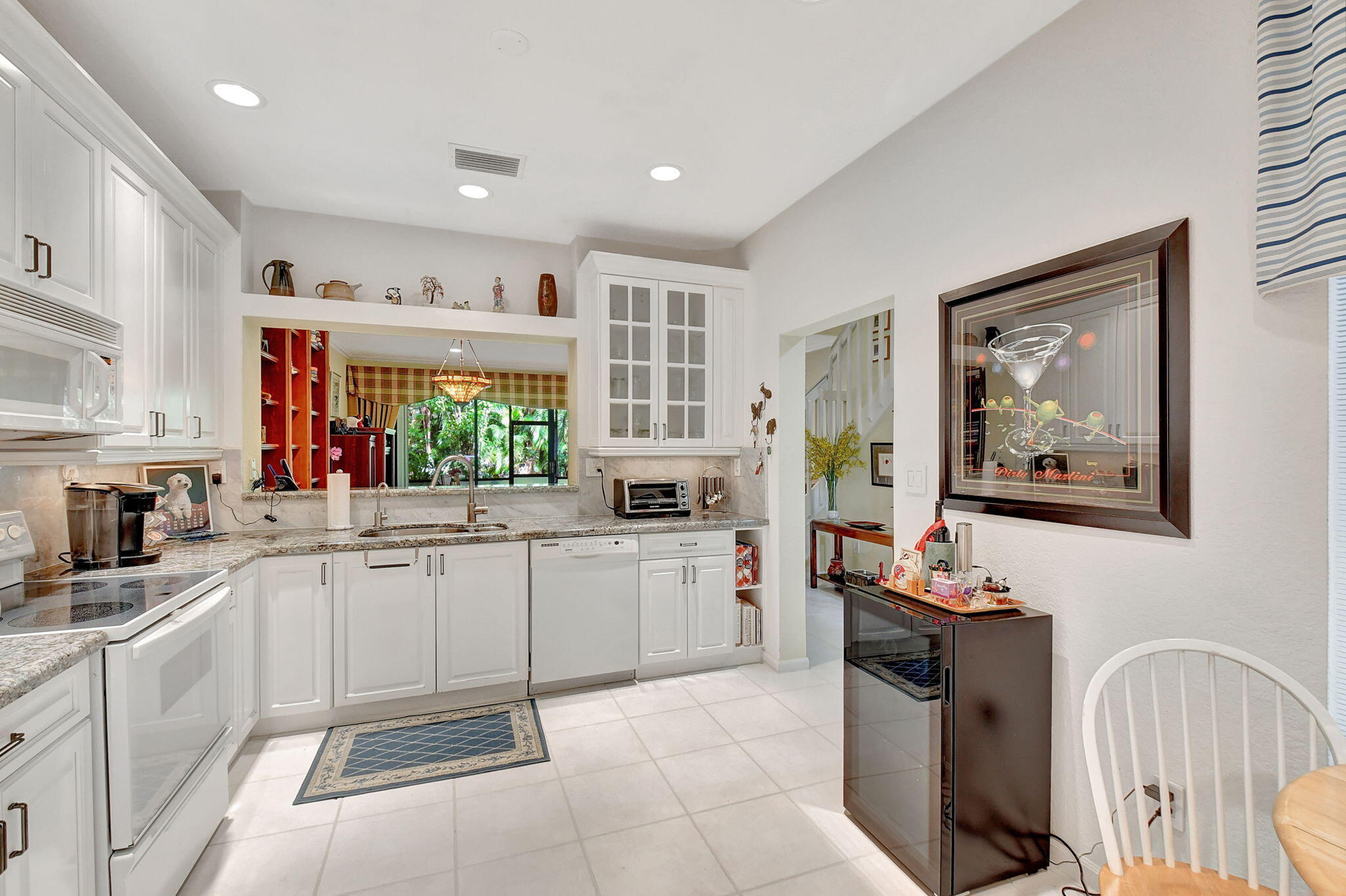 a kitchen with stainless steel appliances a stove a sink and a refrigerator