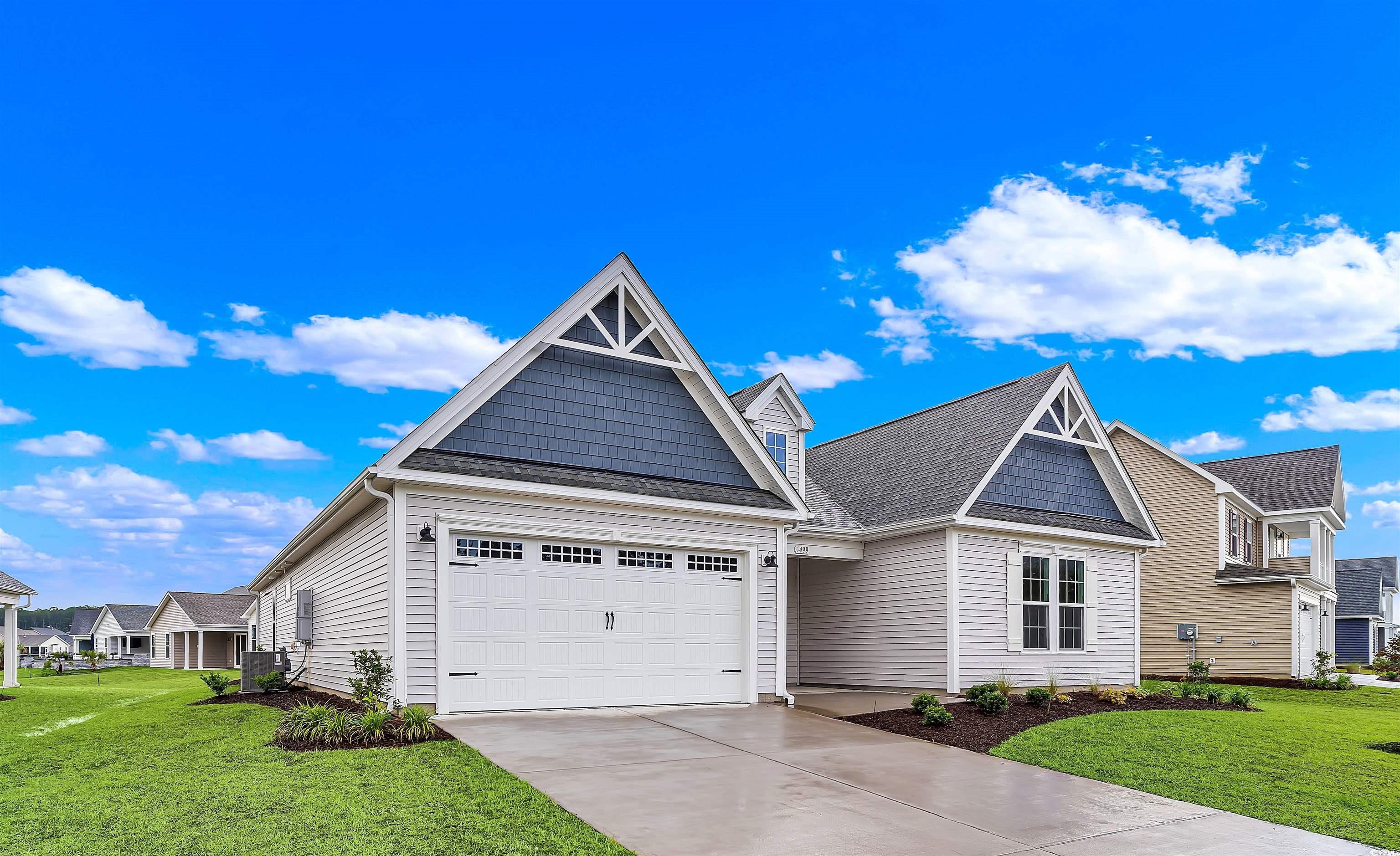 Craftsman-style home featuring a front lawn and a