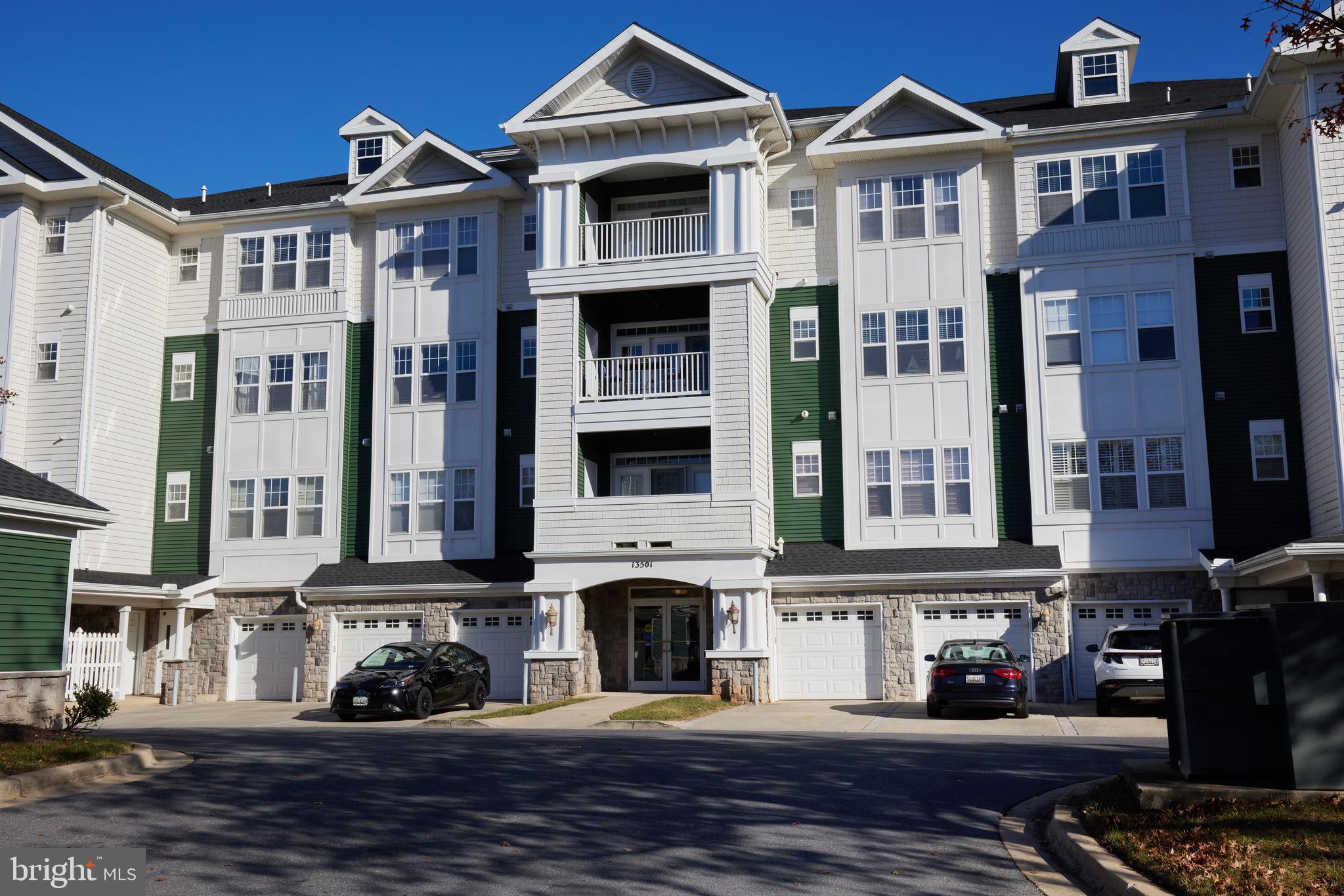 a front view of a residential apartment building with a yard