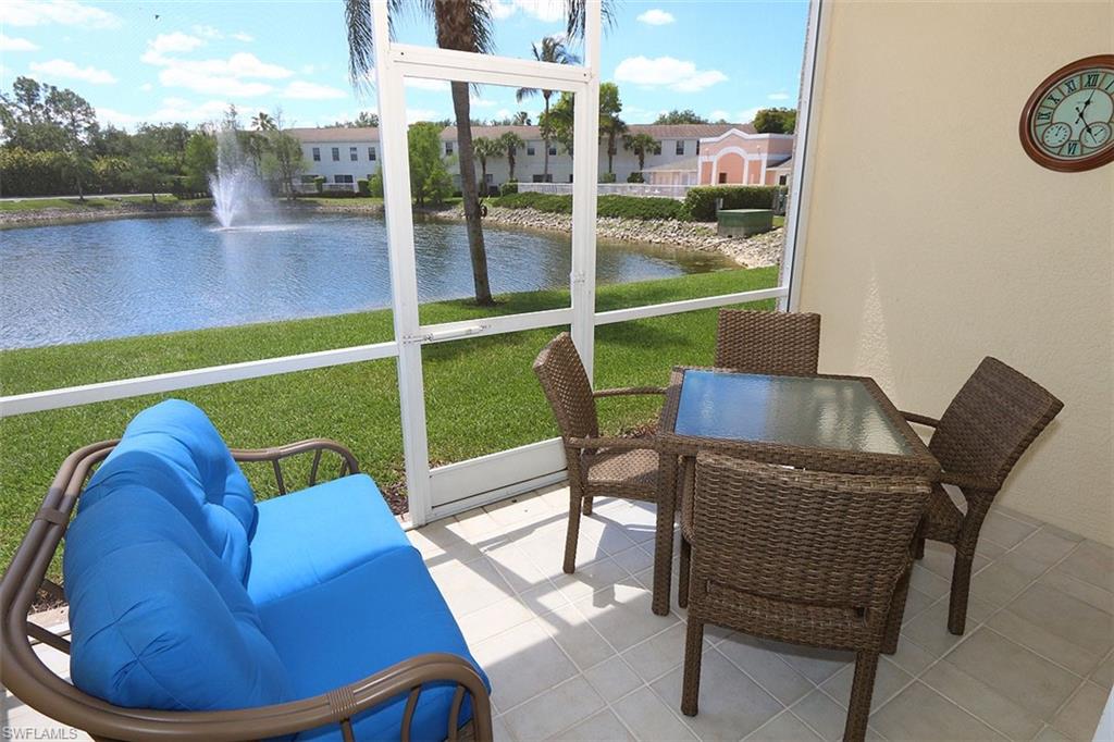 a view of a patio with a table chairs and a backyard