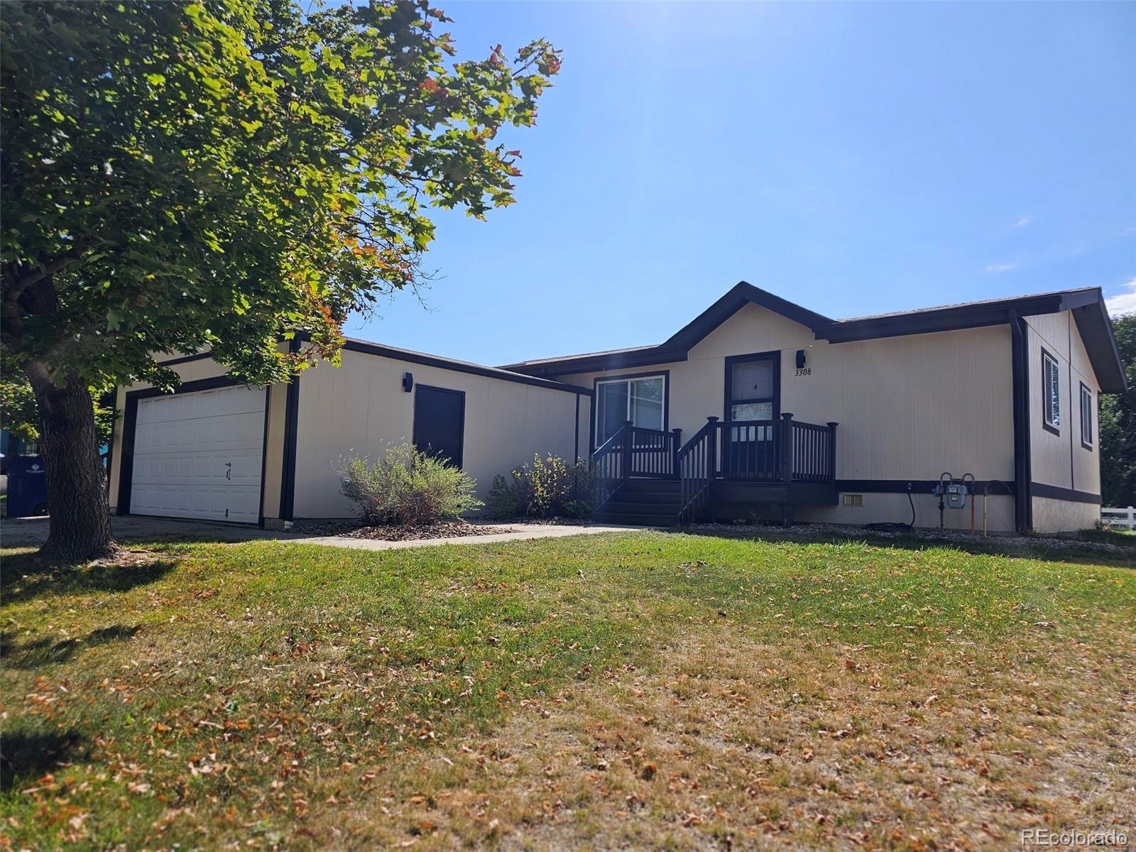 a view of a house with a yard and garage