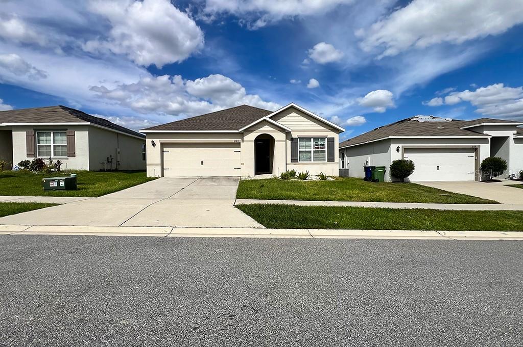 a front view of a house with a yard