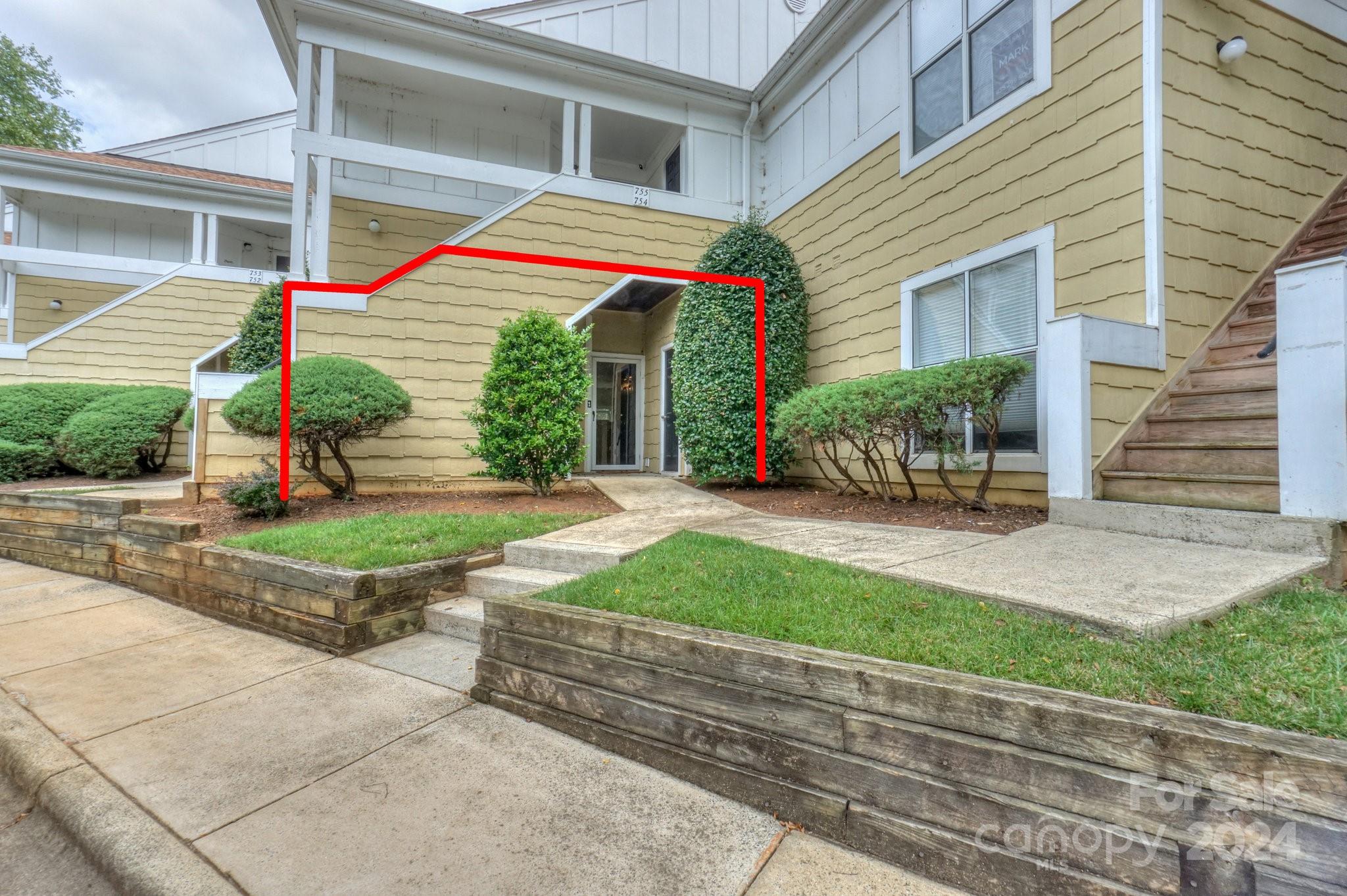 a view of a house with a yard and plants