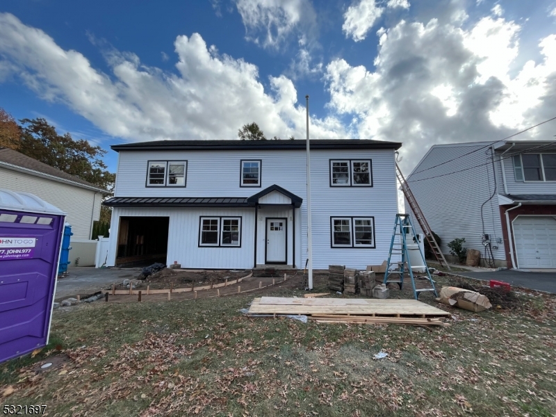 a front view of a house with yard garage and outdoor seating