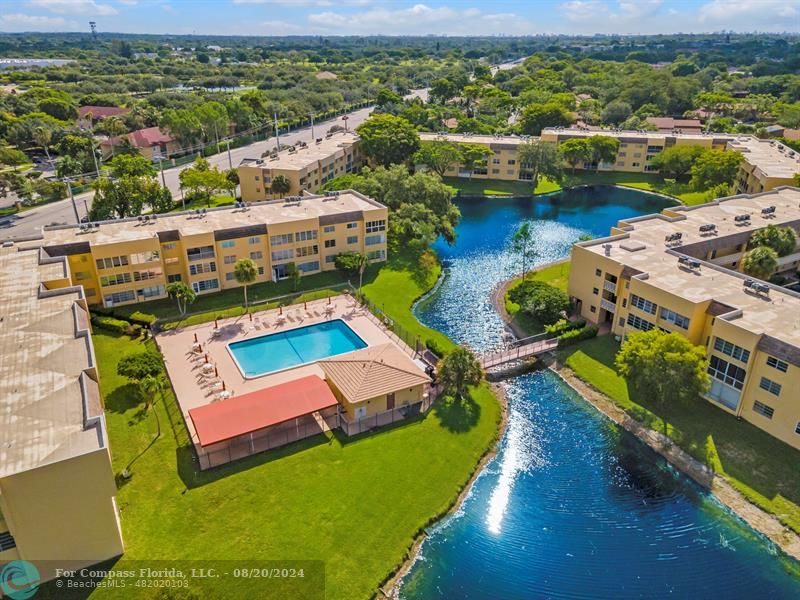 an aerial view of a house with yard swimming pool and outdoor seating