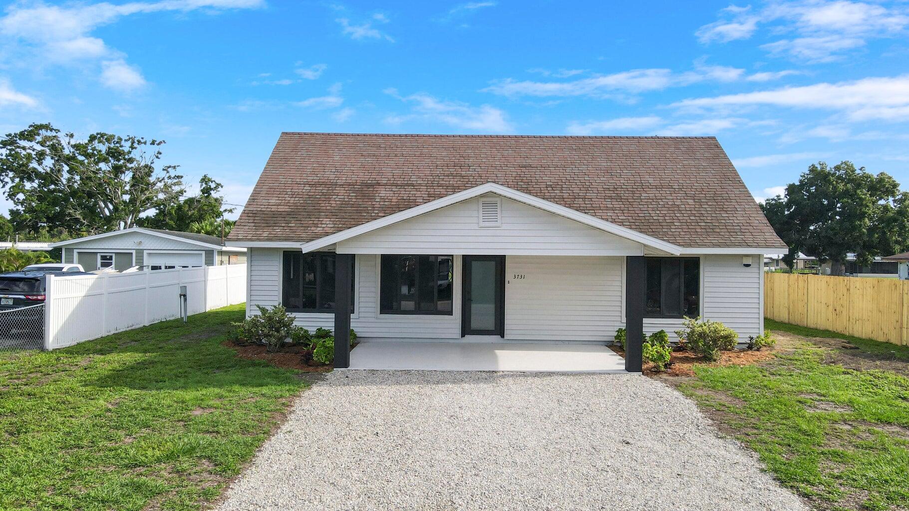 a front view of house with yard and outdoor seating