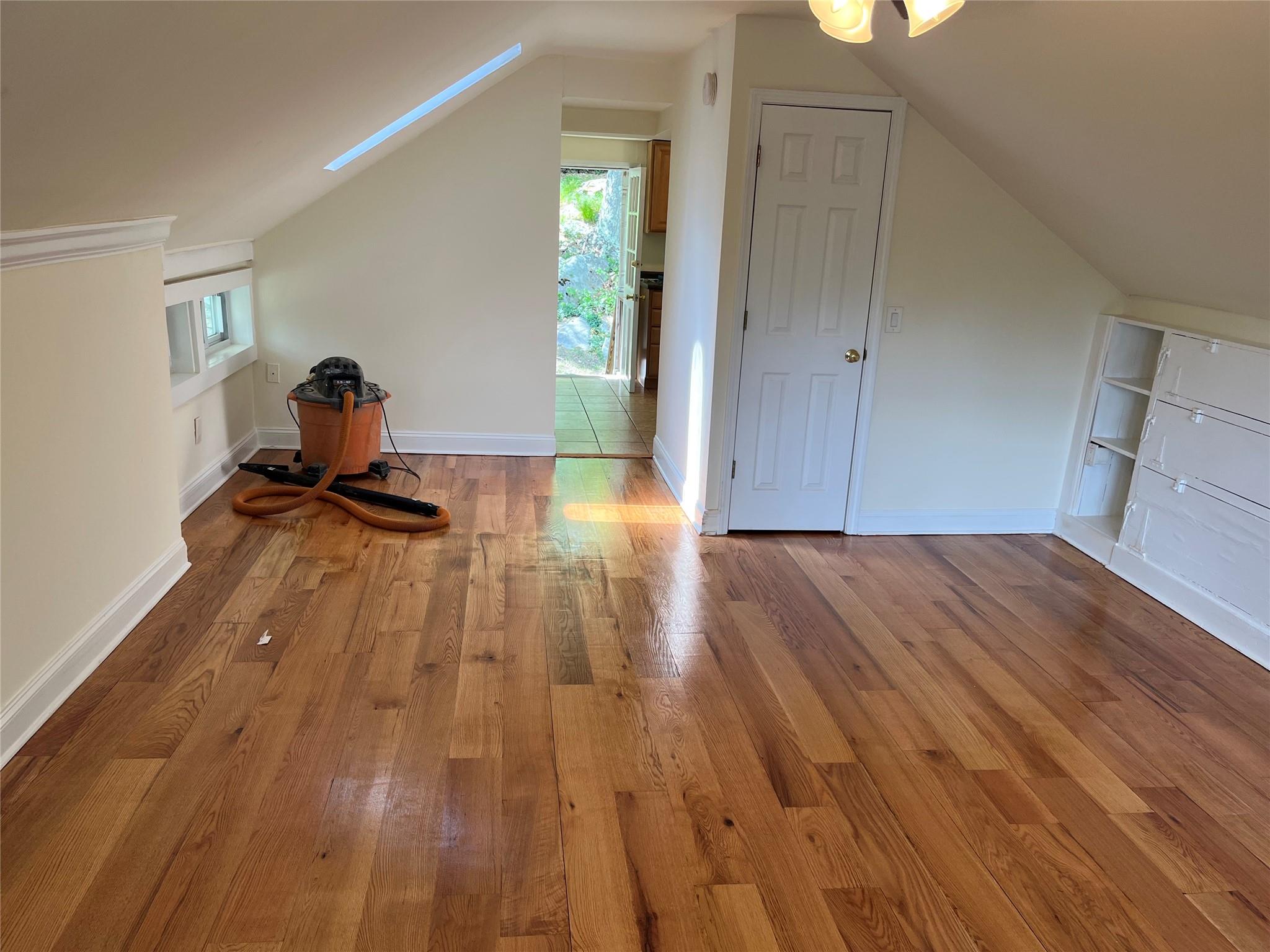 a view of a room with wooden floor