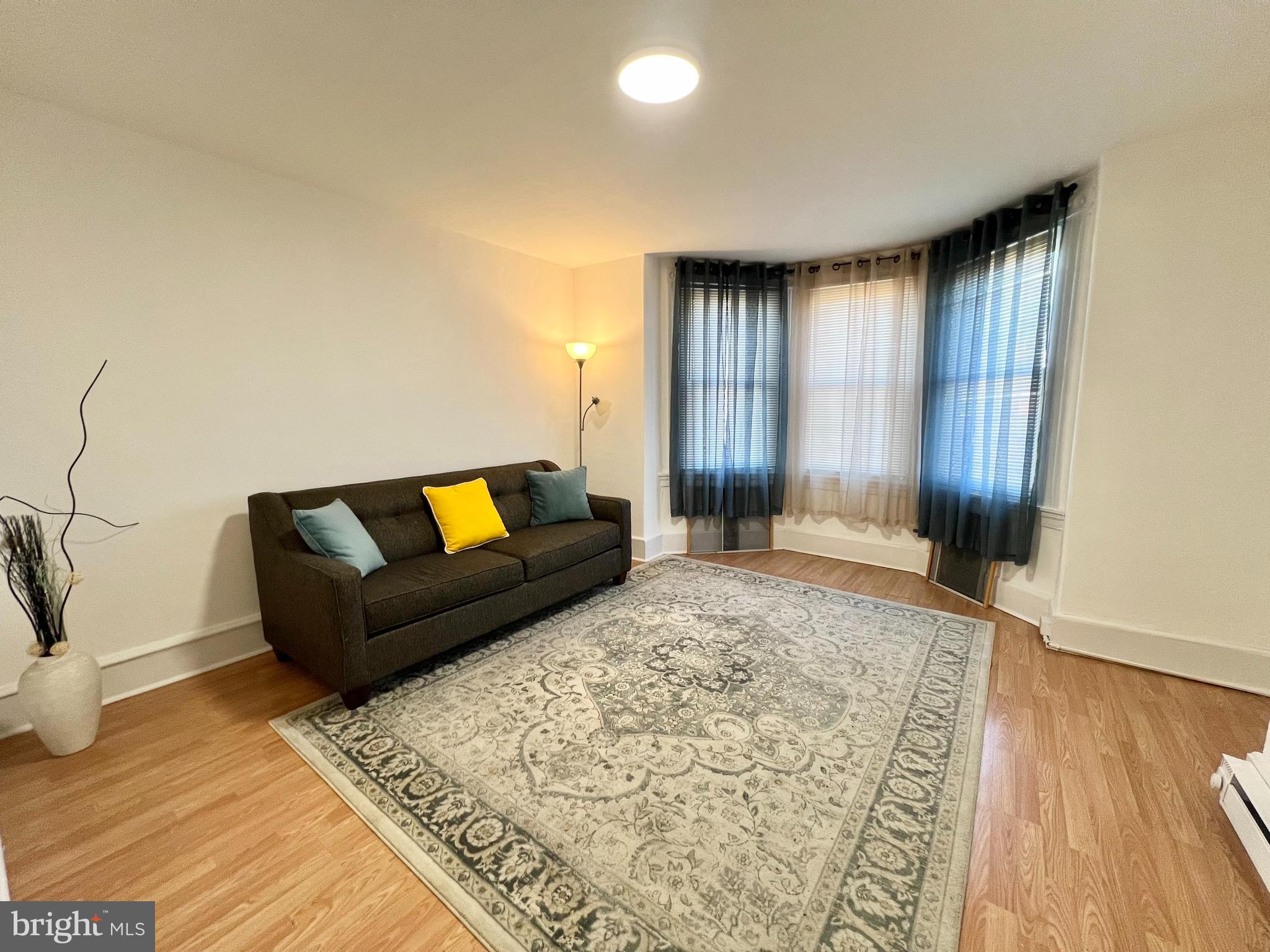 a living room with a couch and a window