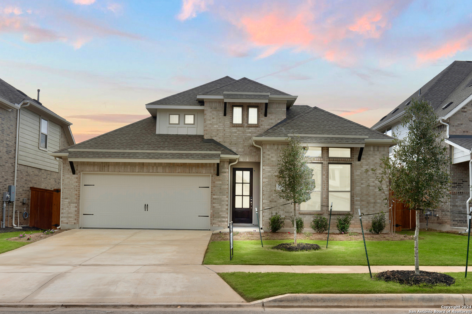 a front view of a house with a yard