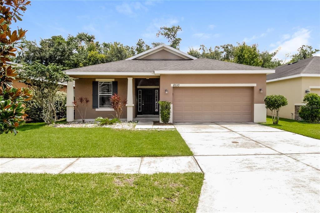 a front view of a house with a yard and garage