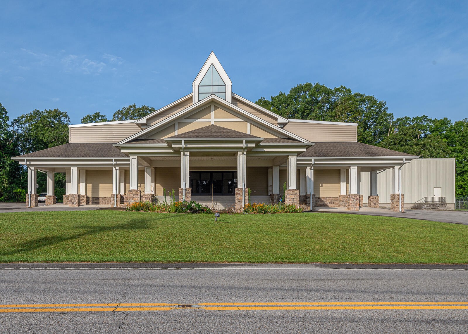 a front view of a house with a garden