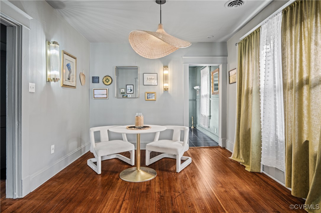 a view of a dining room with furniture window and wooden floor