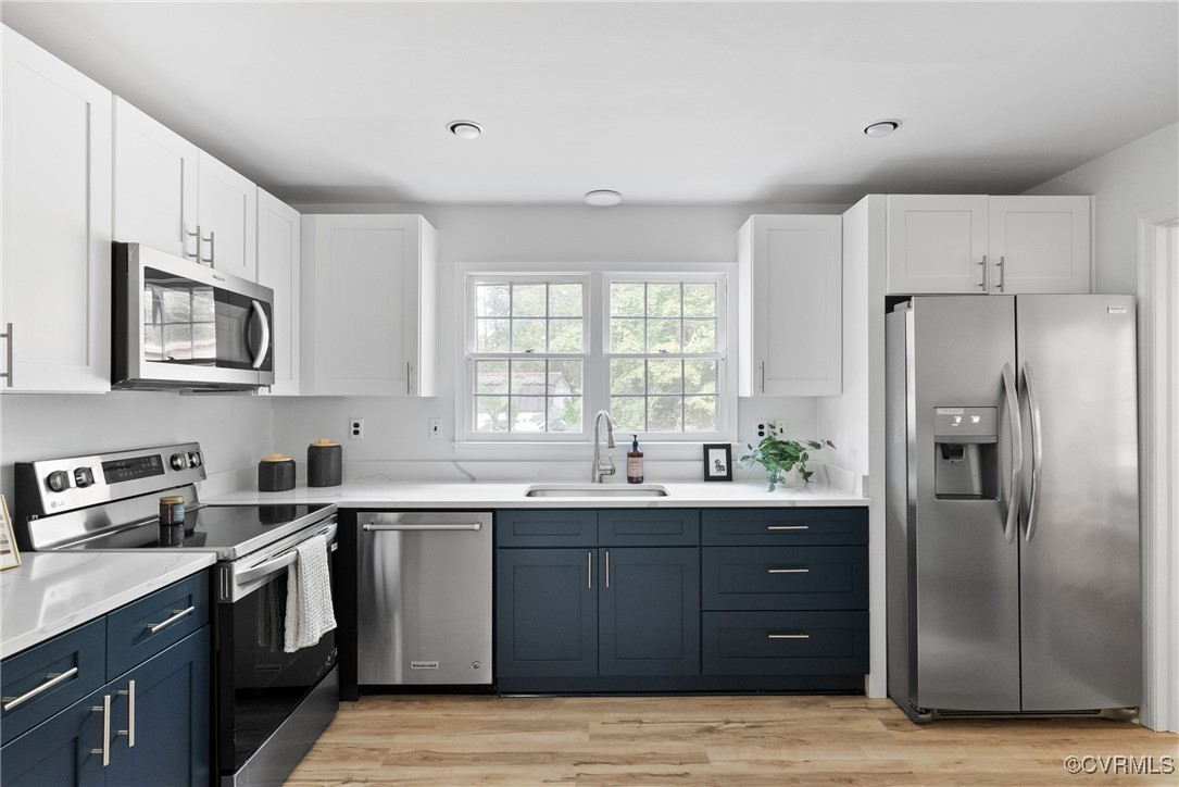 a kitchen with a sink stove and refrigerator