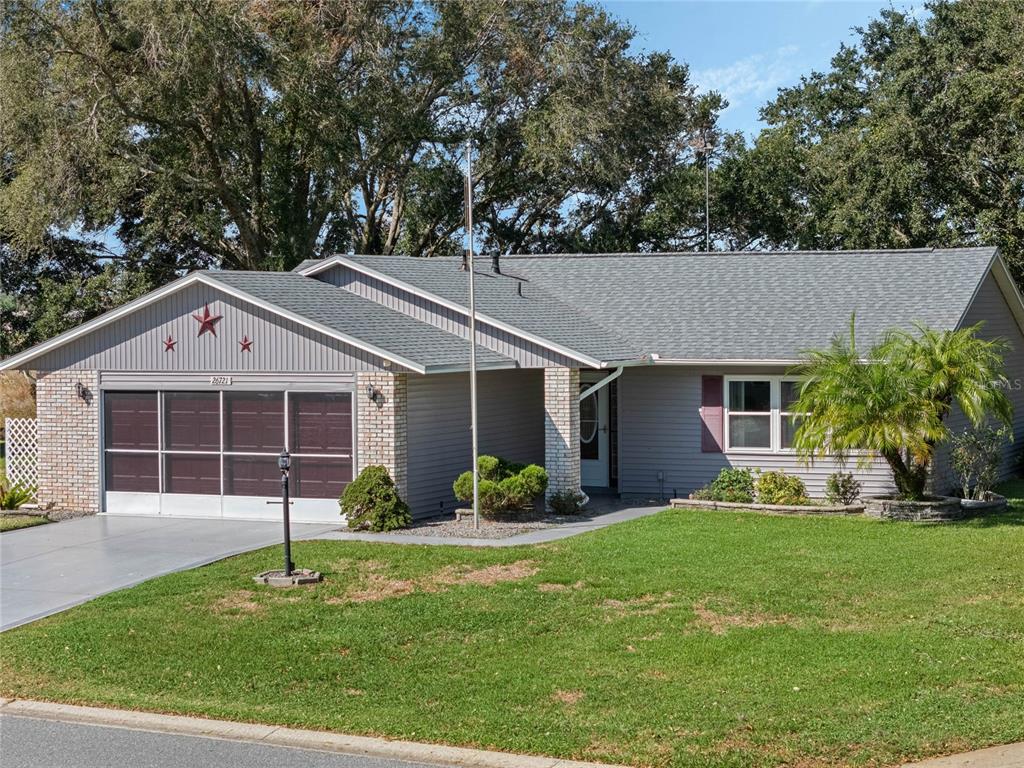 a front view of a house with a yard and garage